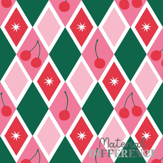 A repeating argyle-style pattern with alternating pink, red, and dark green diamonds outlined in white, decorated with cherry motifs and white starburst shapes. A faint watermark reading 'Material Difference' appears near the lower right.