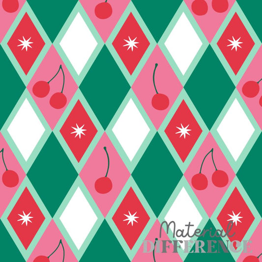 A repeating argyle-style pattern with pink and green diamonds, white diamond centers, red cherries, and white starburst motifs. The words 'Material DIFFERENCE' appear