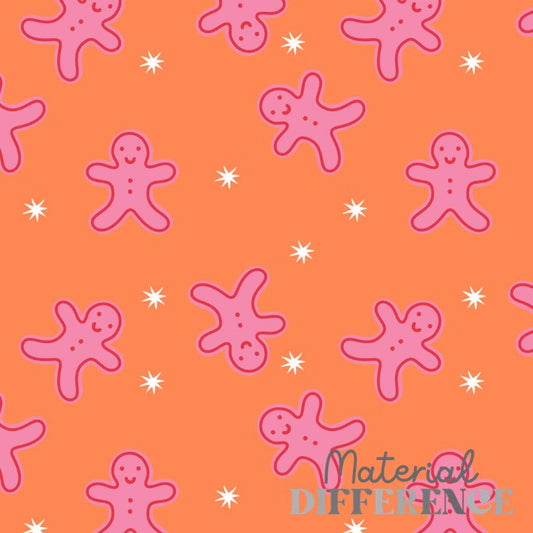 A repeating pattern of pink gingerbread men and small white starburst shapes on a bright orange background, with the words 'Material Difference' in script and block text at the bottom right.