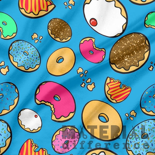 Colorful donut pattern on a blue fabric background with 'Material Difference' branding.
