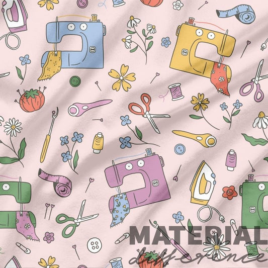 Pattern of sewing-related items on a pink background