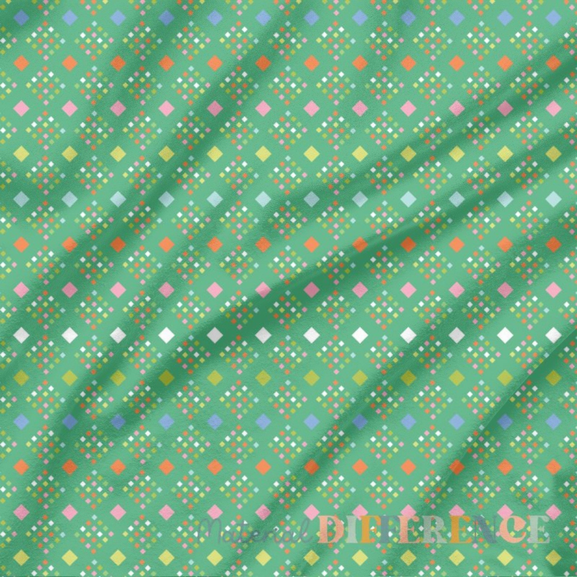 Colorful geometric pattern on green fabric with 'Material Difference' branding.