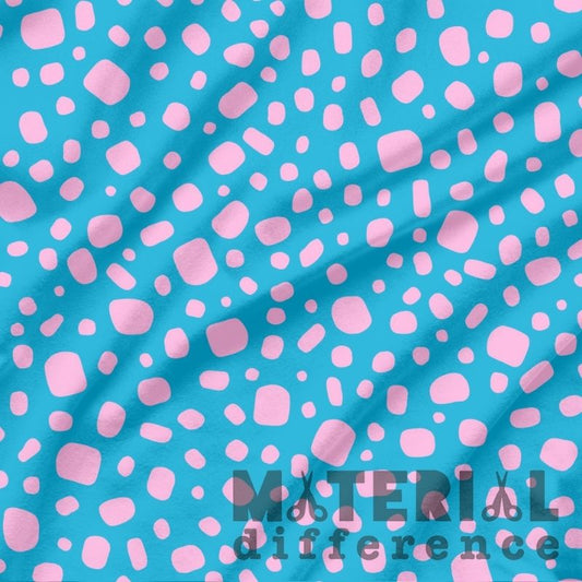 Fabric with pink abstract pattern on a blue background, featuring 'Material Difference' branding.