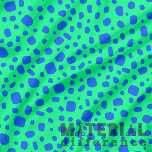 Green fabric with blue polka dot pattern and 'Material Difference' branding.