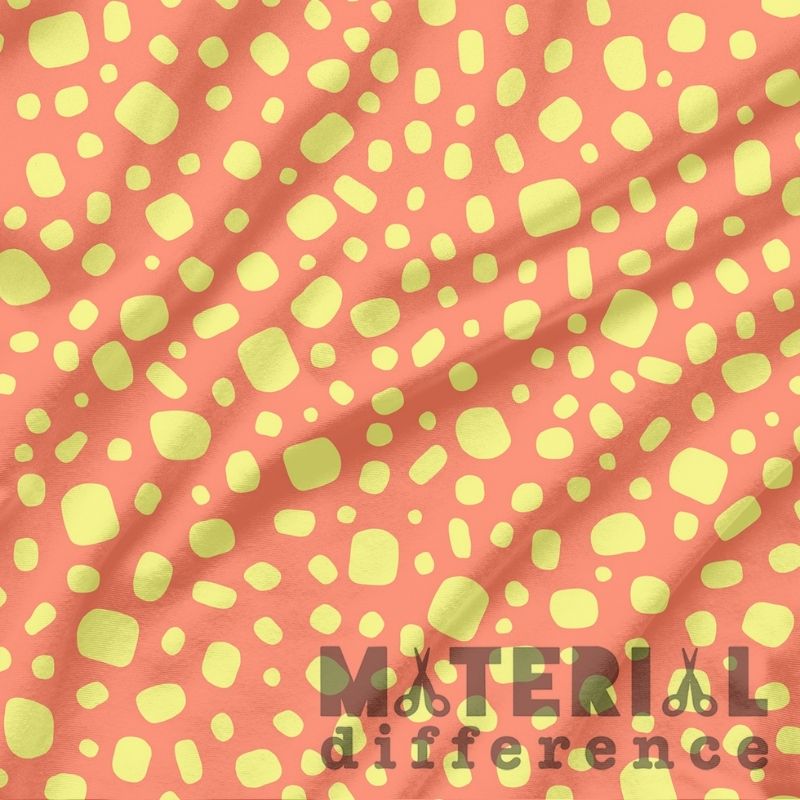 Fabric with yellow abstract pattern on an orange background, featuring 'Material Difference' text.