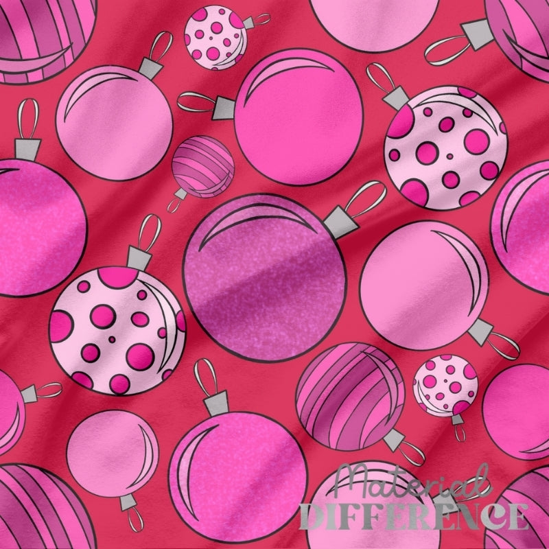 Pattern of pink Christmas ornaments on a red background with 'The Material Difference' branding.