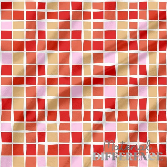 Patterned fabric with red, orange, and pink squares on a white background, featuring 'The Material Difference' brand.