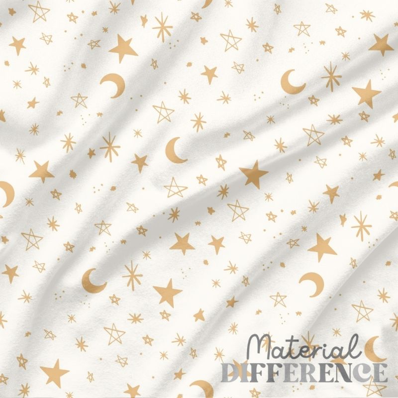 White fabric with gold stars and crescent moons pattern, featuring 'Material Difference' branding.